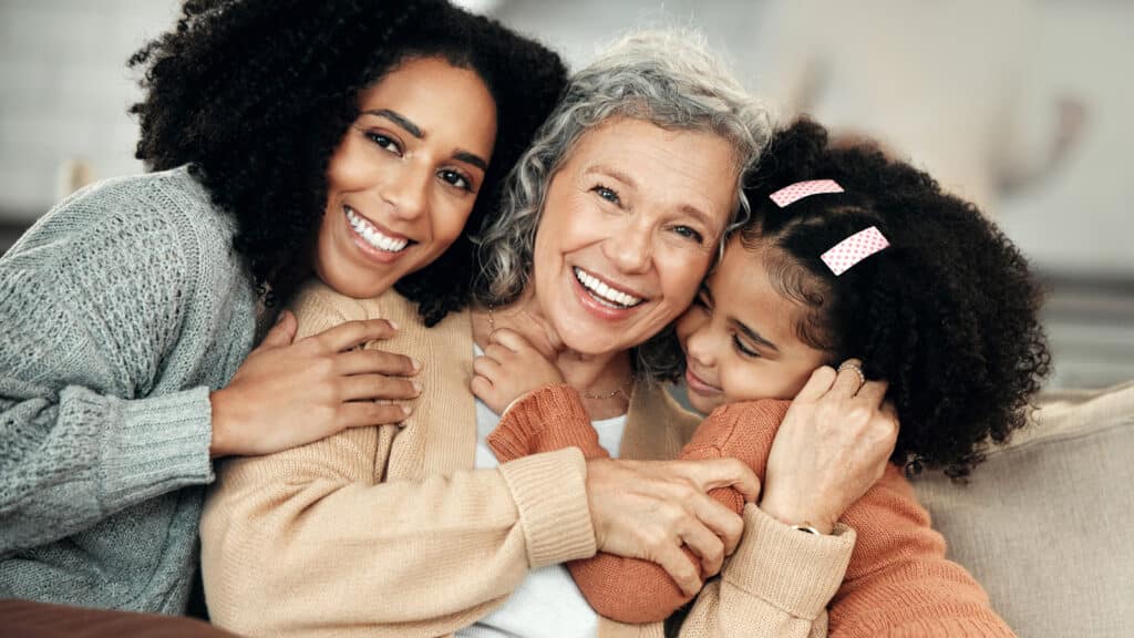Older woman smiling with family around her